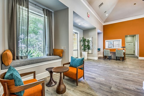 A living room with a wooden chair and a blue cushion.